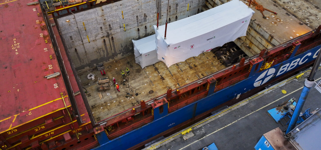 Project cargo stowage and securing inside a vessel hold during marine logistics operations.