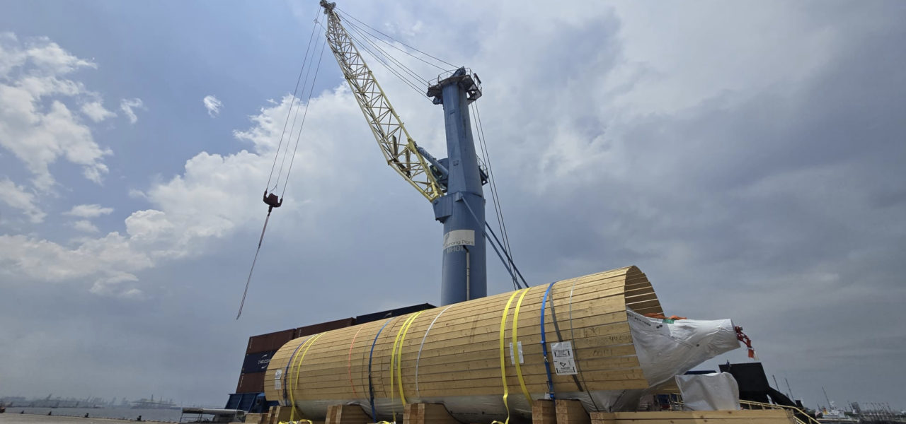 heavy project cargo on truck reloading to barge at port