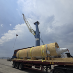 heavy project cargo on truck reloading to barge at port