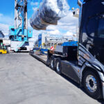 Heavy project cargo unit transferred by crane onto trailer for onward transport from port