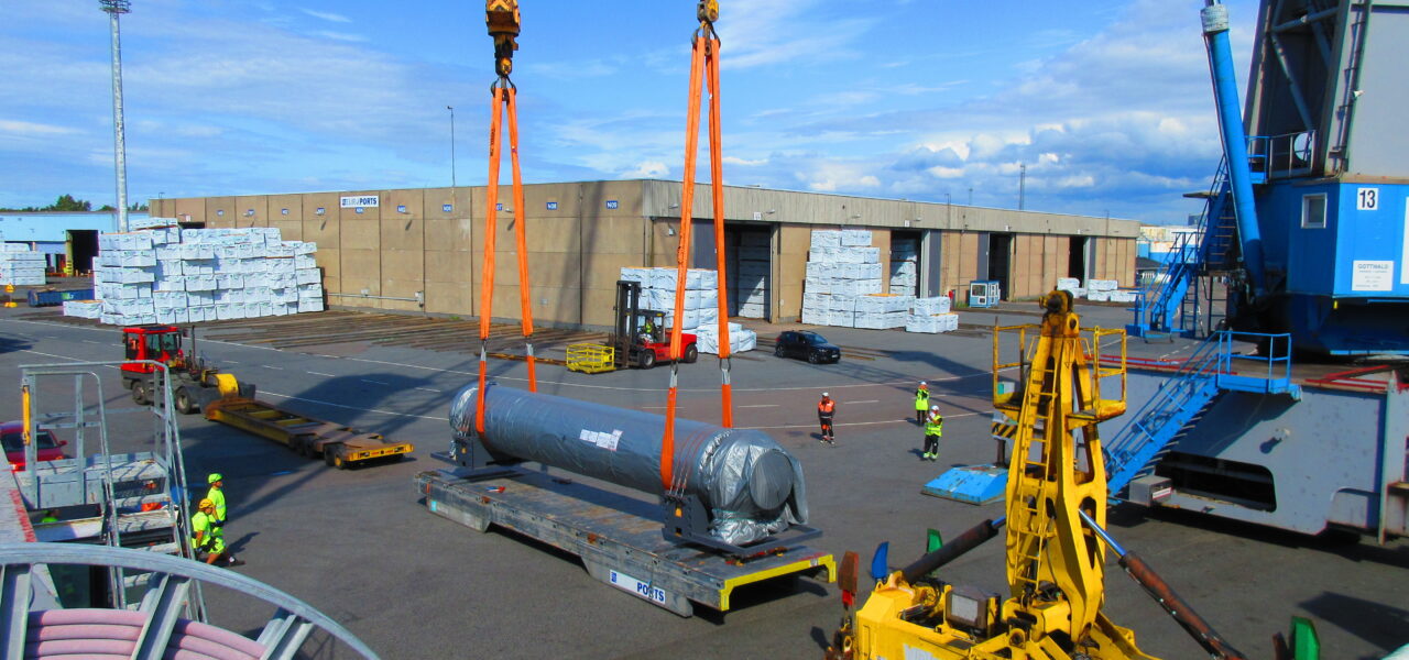 Heavy cargo loading operation featuring oversized industrial equipment and specialized lifting solutions.