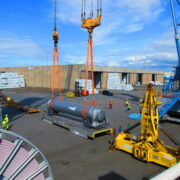 Heavy cargo loading operation featuring oversized industrial equipment and specialized lifting solutions.