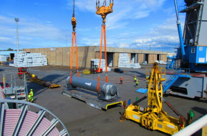 Heavy cargo loading operation featuring oversized industrial equipment and specialized lifting solutions.