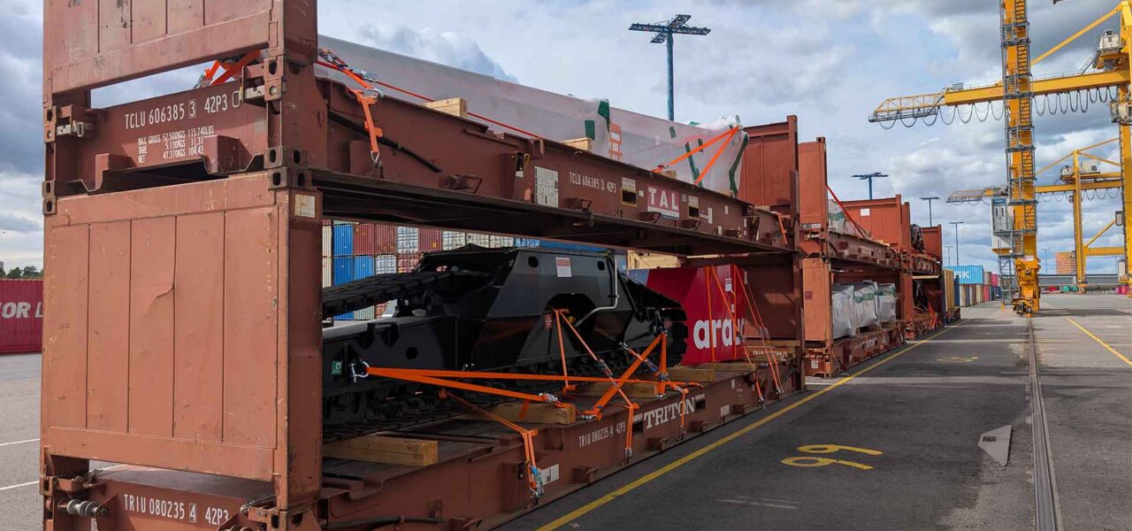 Project cargo loaded into flat rack containers at the Port of Helsinki, demonstrating secure stowage and handling of heavy industrial equipment.
