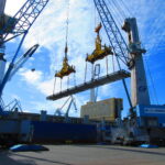 Industrial equipment being loaded for export, highlighting the execution stage of the logistics chain.