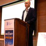 Hacklin's managing director Mikael Grönroos delivering a presentation at The Heavy Lift Group conference, discussing logistics expertise, international freight forwarding, and project cargo operations in China.