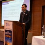 Hacklin Shanghai representative Eric Wang presenting the company's project cargo and heavy-lift logistics capabilities during a THLG conference session focused on global logistics and industrial projects.