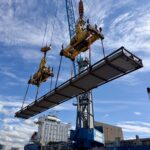Logistics professional observing cargo handling activities firsthand to better understand port operations and shipment execution.