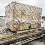 Time-critical project cargo positioned on an airport handling platform for export air freight services.