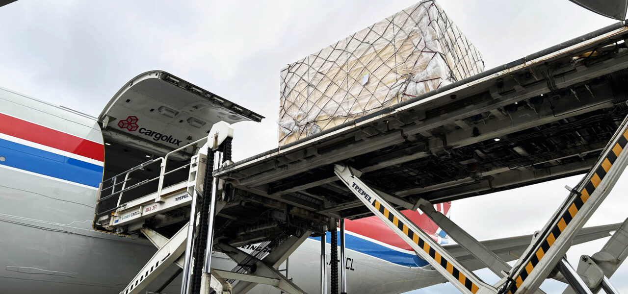 Industrial cargo being loaded onto a Cargolux aircraft for air freight transport from Finland to Japan.