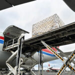 Industrial cargo being loaded onto a Cargolux aircraft for air freight transport from Finland to Japan.