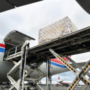 Industrial cargo being loaded onto a Cargolux aircraft for air freight transport from Finland to Japan.