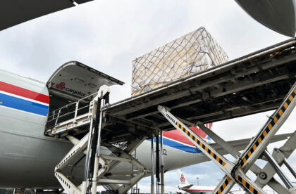 Industrial cargo being loaded onto a Cargolux aircraft for air freight transport from Finland to Japan.