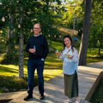 Team members of Hacklin Logistics enjoying a networking moment during a wellbeing event in a Finnish natural setting.